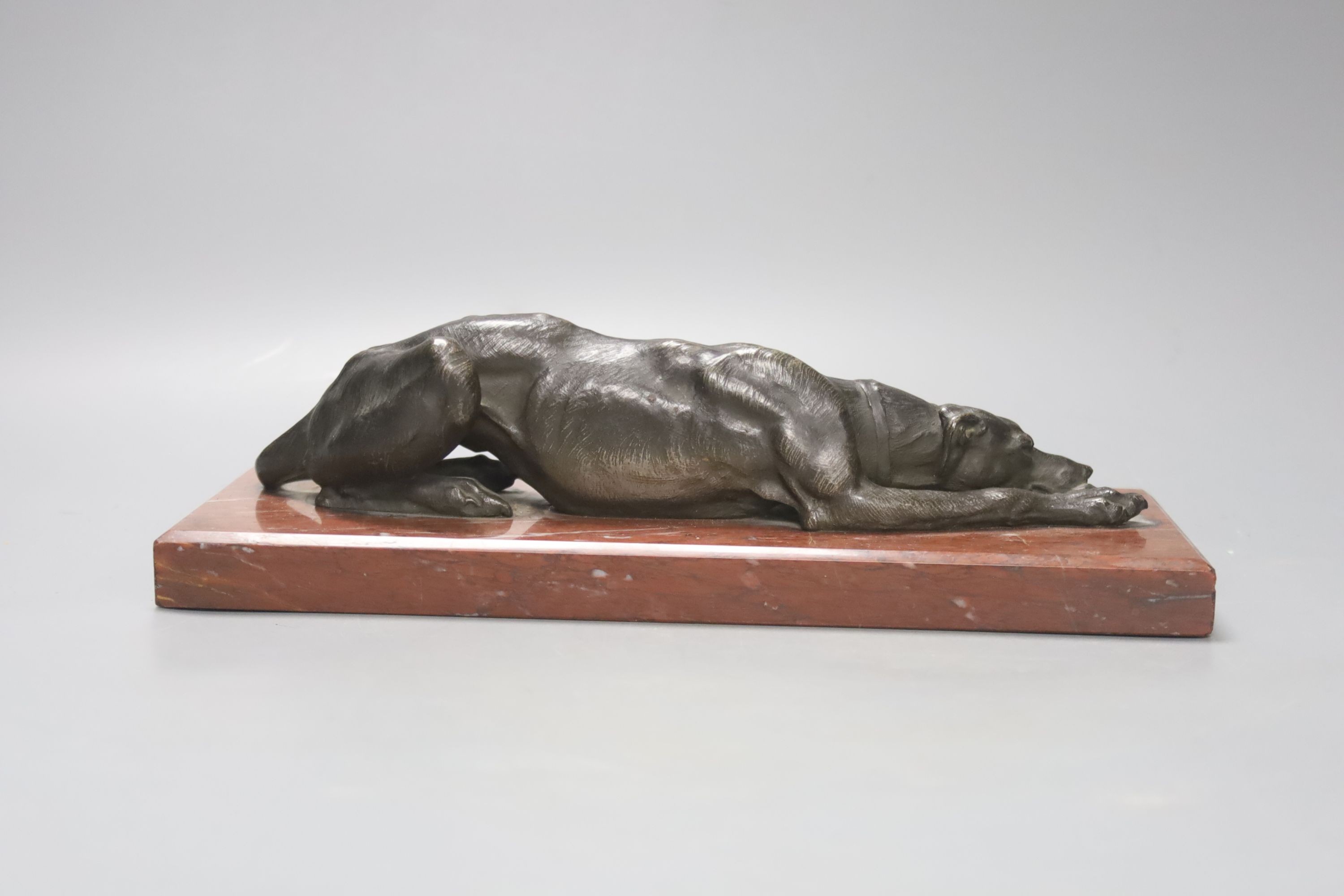 Animalier School, A 19th century bronze figure of a recumbent greyhound, on marble base, length 27cm